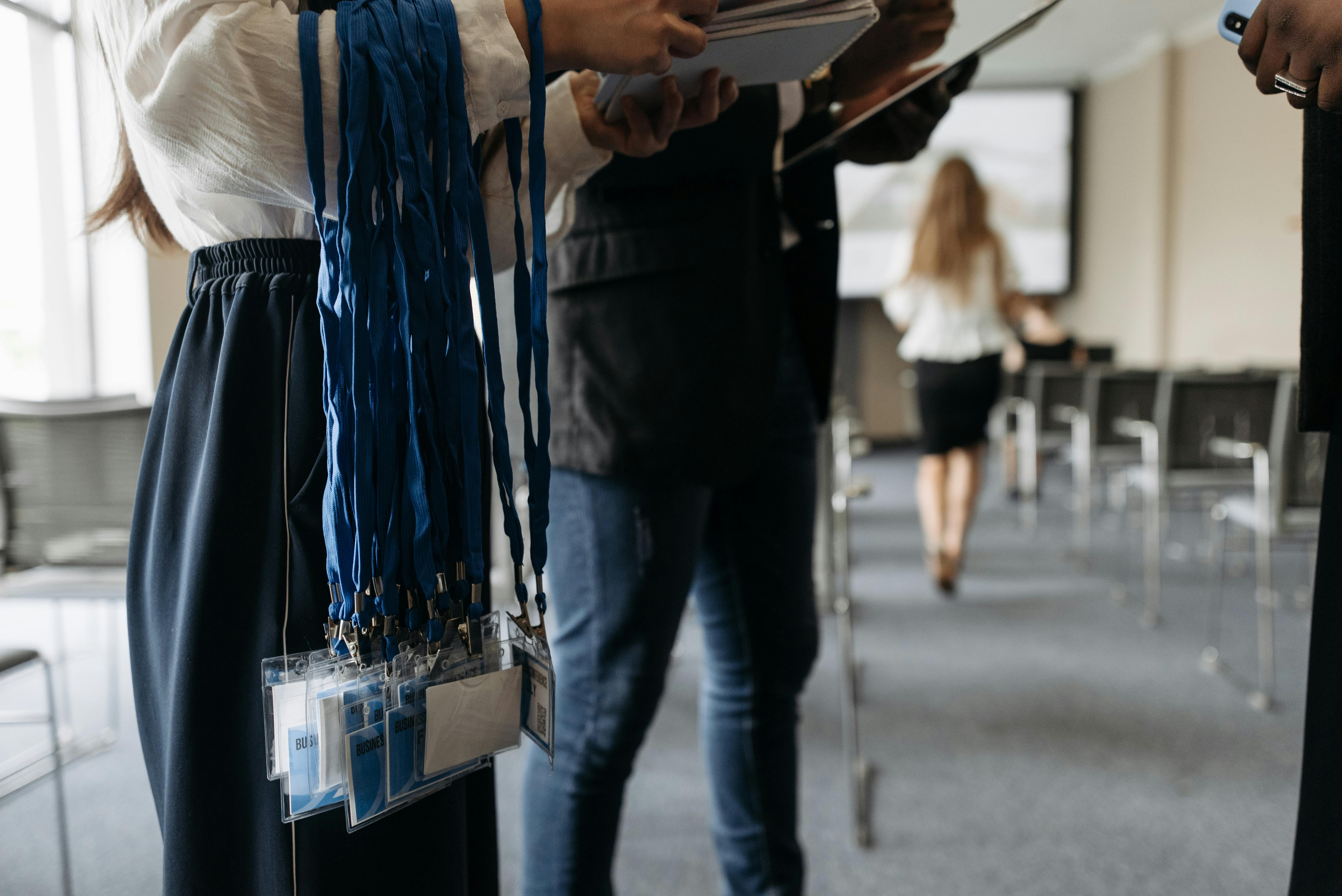 Conference badges on blue lanyards prepared for attendees.