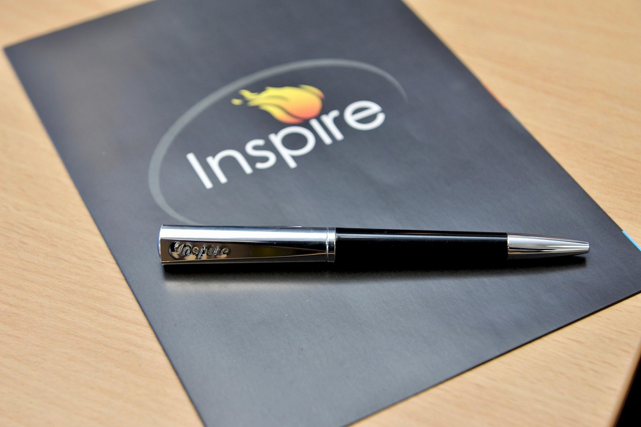 Branded brochure and pen laid out on a desk.